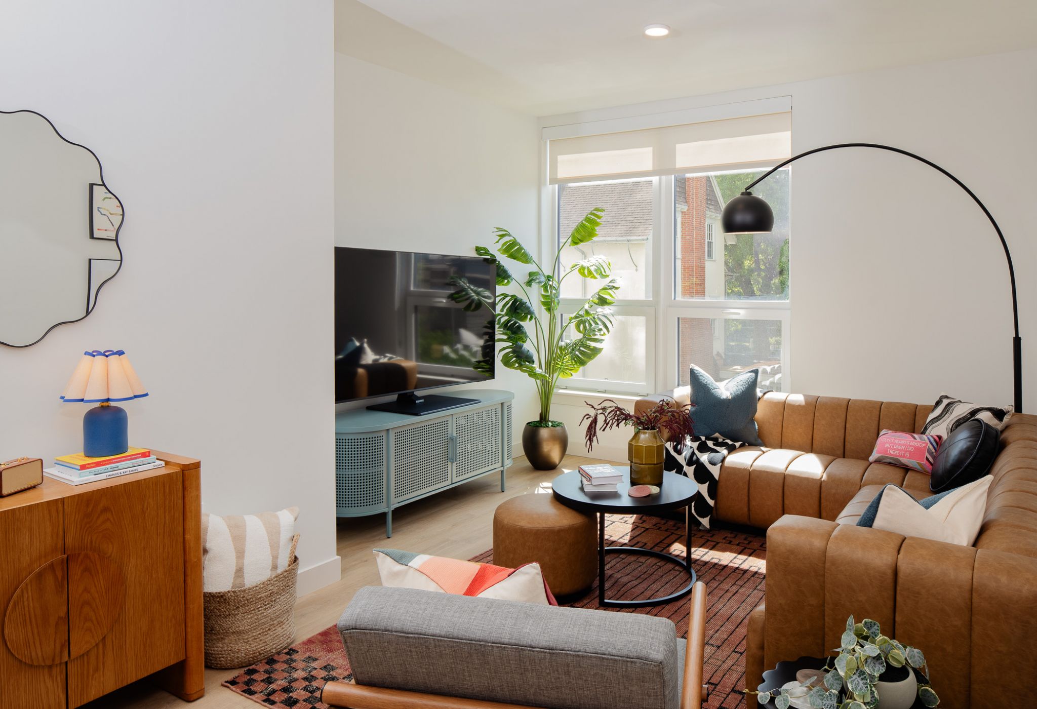 VERVE Ann Arbor student apartment living room with modern furniture including couch, large TV, coffee table and chair